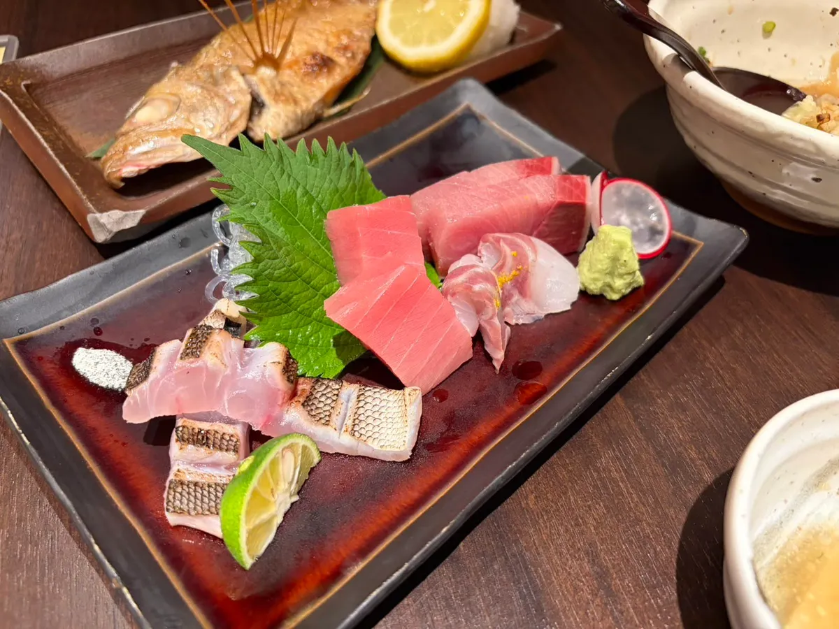 Sashimi platter with tuna, yellowtail, and grilled fish at a Kanazawa izakaya