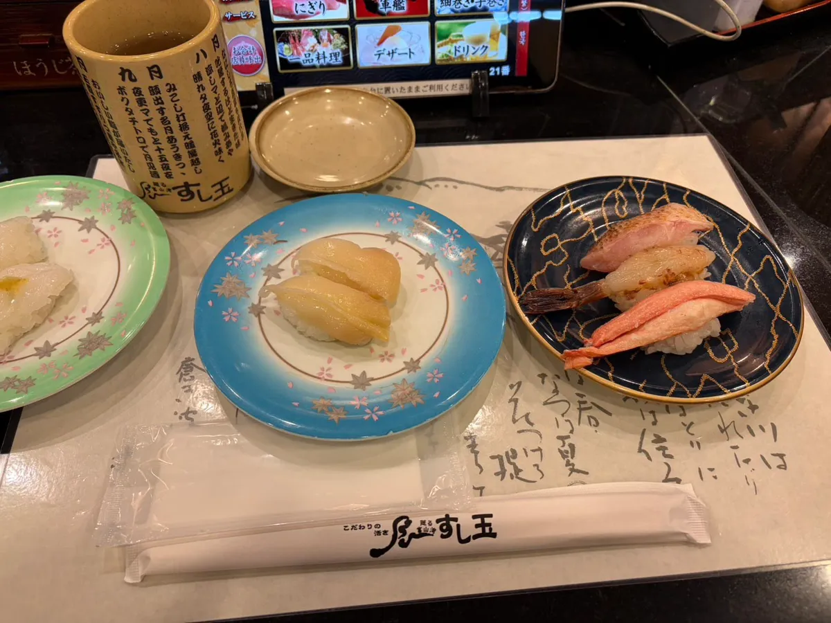 Crab nigiri sushi plates at a Kanazawa kaiten-zushi restaurant