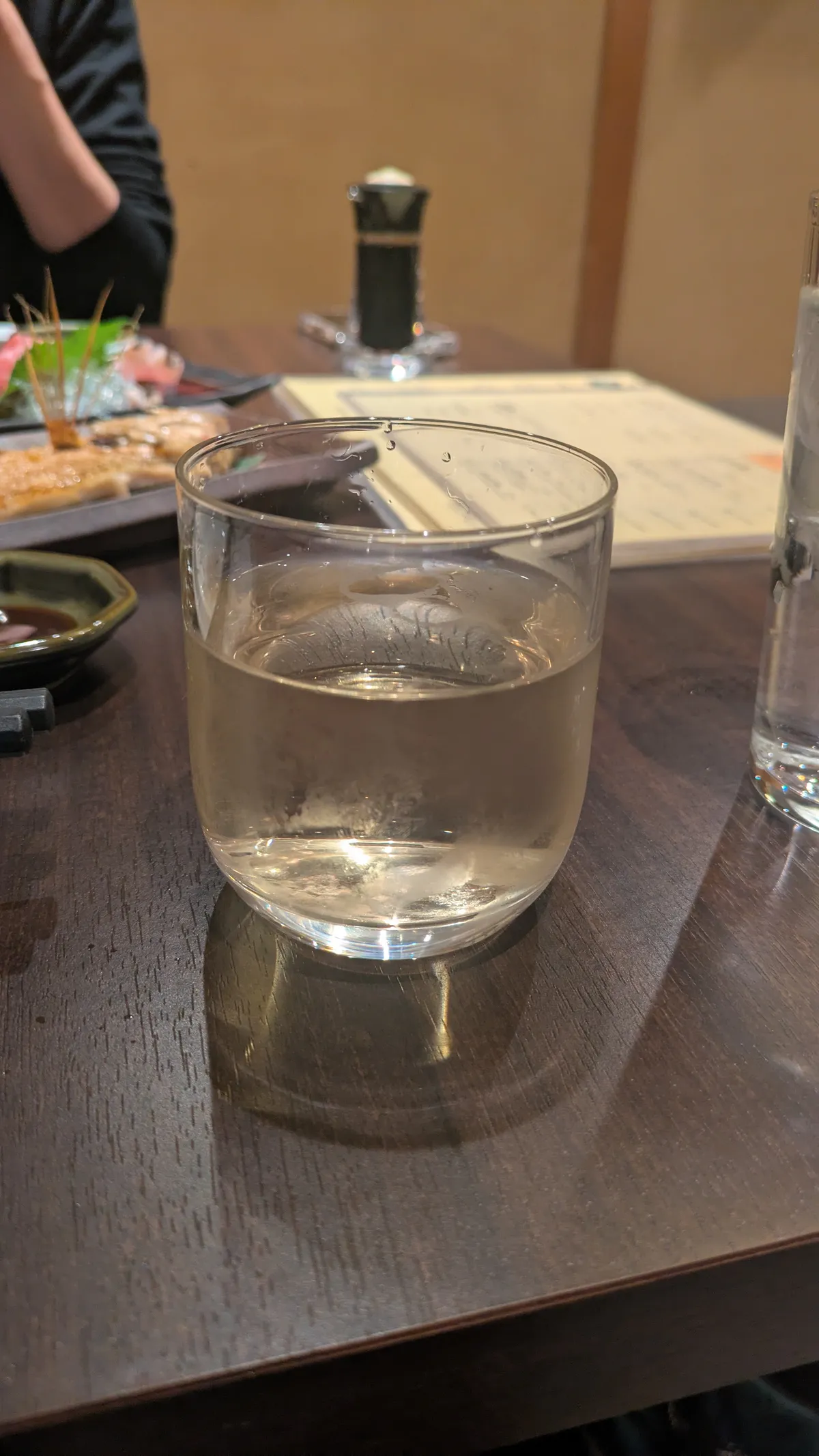 Glass of clear sake at a Kanazawa izakaya, December 2025