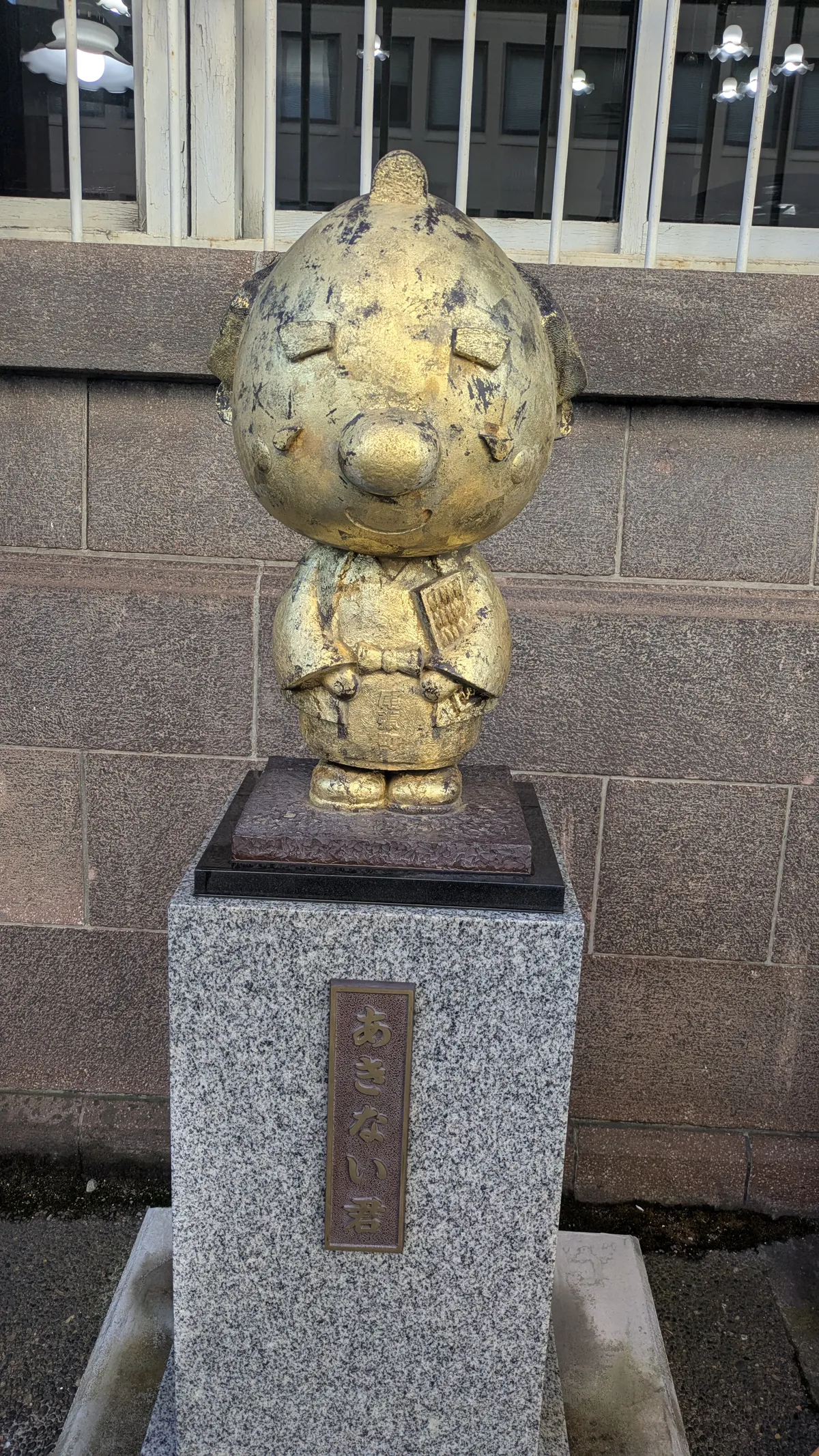Golden mascot statue with a topknot near Kanazawa Station in December
