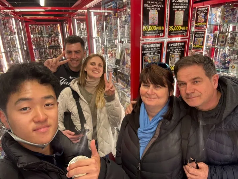 Tour group exploring an Akihabara collectibles store